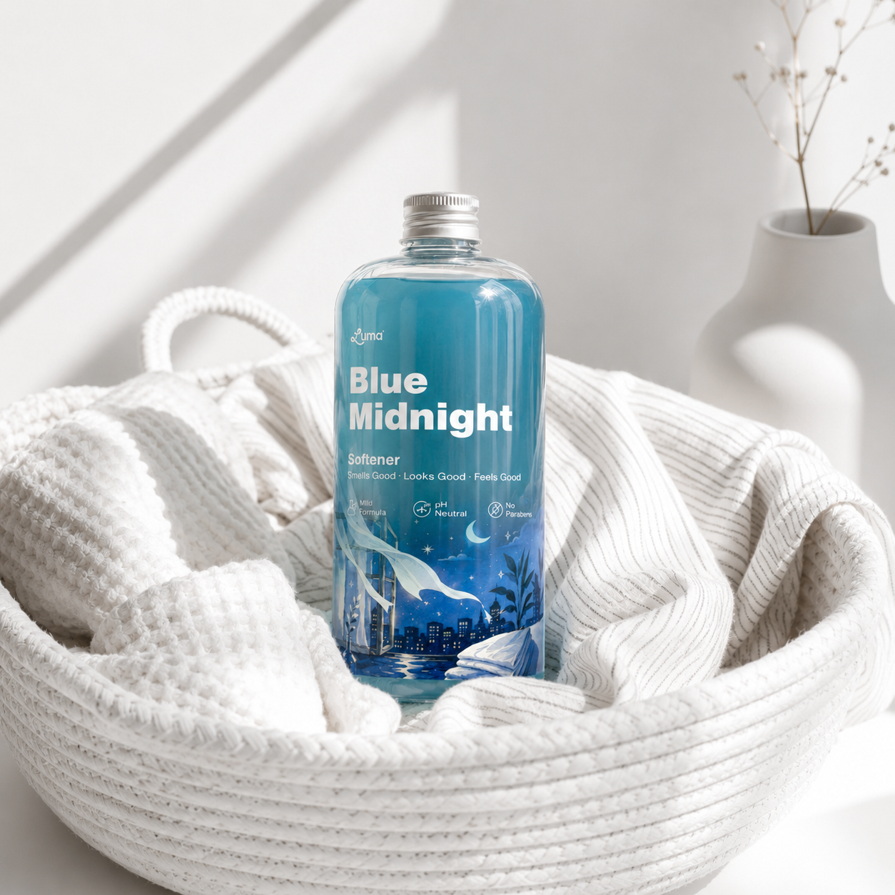 Luma Blue Midnight Fabric Softener sitting in a laundry basket
